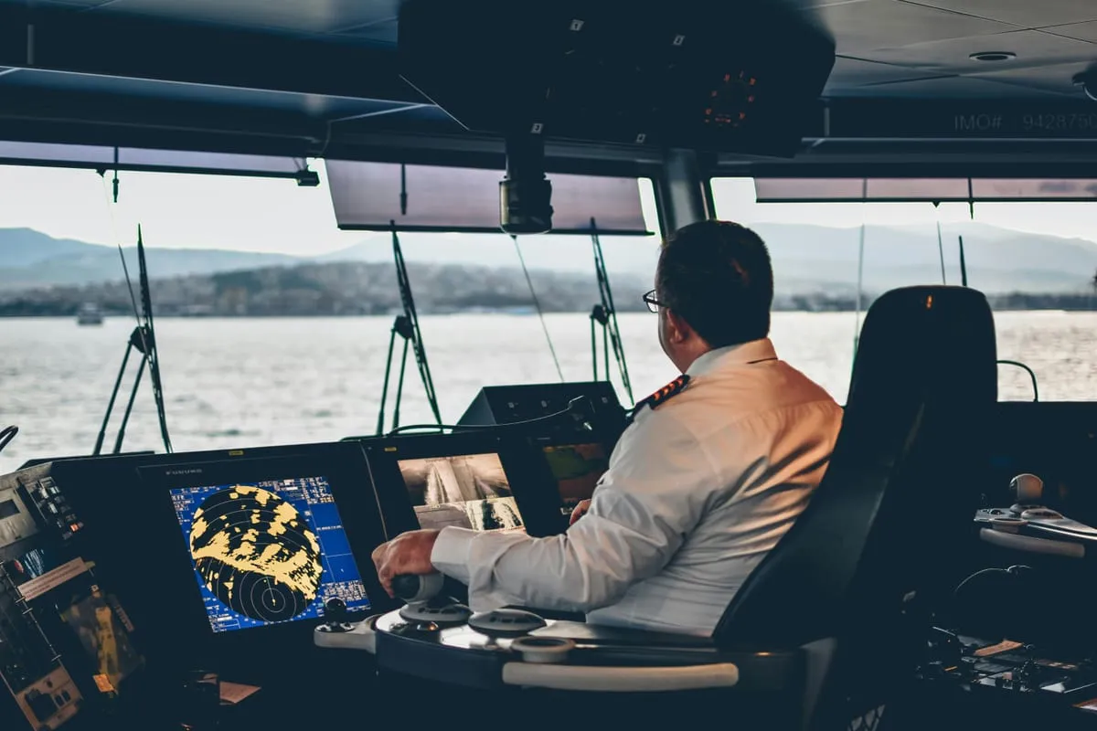 Officer at the controls on a ship's bridge